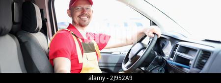 Unshaven male courier sitting in car smiling Stock Photo
