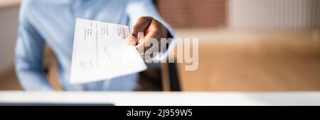 Photo Of Businessman Giving Cheque Over White Desk Stock Photo