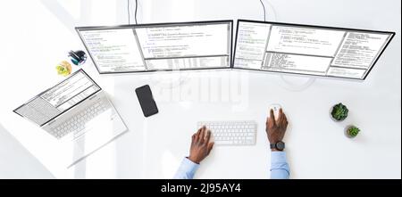 Computer programmer writing program code on computer in office Stock Photo