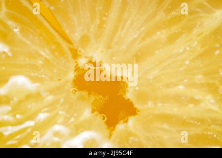 Close up of sliced lemon in the tea with water bubbles. Stock Photo