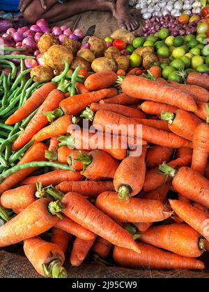 pile of fresh carrots and vegetables in a market Stock Photo