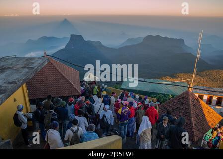 ADAM'S PEAK, SRI LANKA - MARCH 20, 2015: Pilgrims greet the dawn in a Buddhist temple on top of Adam's Peak Stock Photo