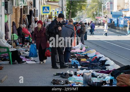 ROSTOV-ON-DON, RUSSIA - OCTOBER 03, 2021: Elderly woman walks through the flea market in the city street Stock Photo