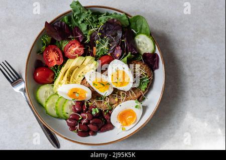 Medium boiled eggs with sasld, healthy breakfast Stock Photo