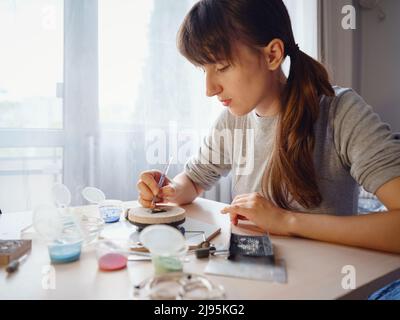 Lifestyle concept, work from home to reinvent your life - Jewelry designer workplace. Woman make jewelry. Georgian minankari enamel manufacturing tech Stock Photo