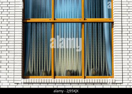 The church has a classic white brick facade and a large rectangular window with six sections. Stock Photo