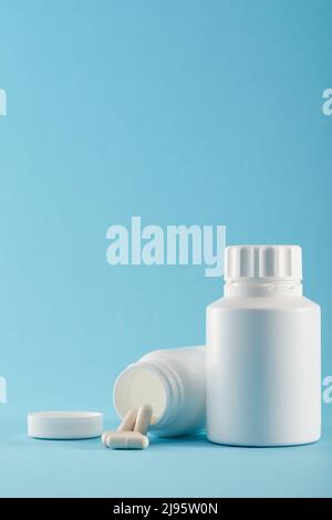 Blank medicine bottle on blue background Stock Photo