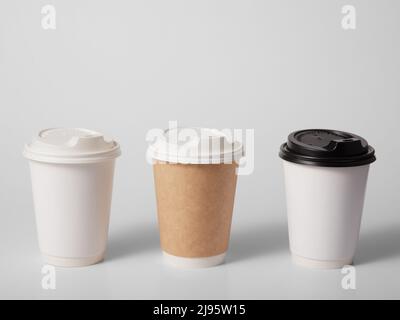 Three takeaway paper cups on white background. Stock Photo