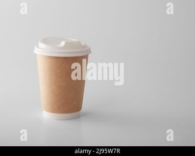 Brown takeaway paper cup with white plastic lid. Stock Photo