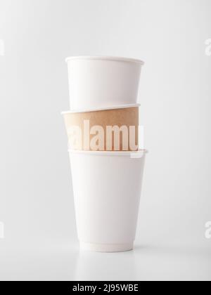 Three takeaway paper cups on white background. Stock Photo