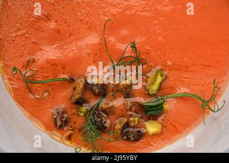 Bowl of cold tomato gazpacho soup with pistachios. Summer refreshing food concept Stock Photo