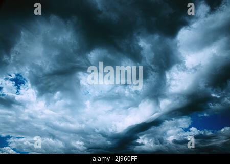 Dark Storm Cloudy Rainy Sky With Rain Heavy Clouds. Sky Natural Background. Weather Forecast Concept. heavy raging turbulent cloudscape. vortical Stock Photo