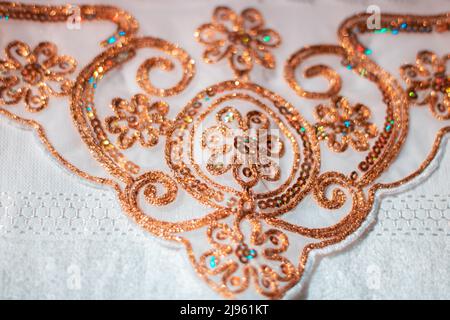 Gold-coloured embroideries Stock Photo