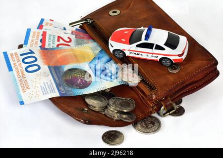 moneybag with swiss moneyand police toy car Stock Photo