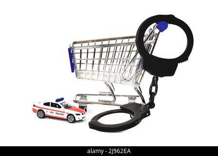 shoplifting shoppingcart  with handcuffs and police toy car Stock Photo