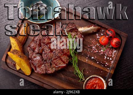 Meat steak on the bone with sauce and potatoes Stock Photo
