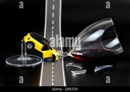 funny drinking and driving scenery accident with toy cars Stock Photo