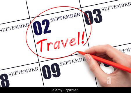 2nd day of September. Hand drawing a red circle and writing the text TRAVEL on the calendar date 2 September . Travel planning. Autumn month. Day of t Stock Photo