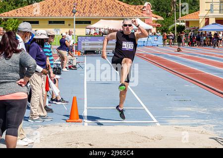 Fort Ft. Lauderdale Florida,Ansin Sports Complex Track & Field National Senior Games,man male long jump competition competitor jumping Stock Photo