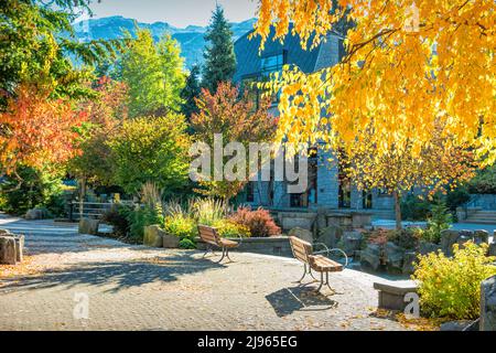 Walkway with colorful trees in downtown Whistler, BC, Canada in autumn Stock Photo