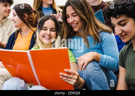 Young multiracial friends studying together outside university - School education concept Stock Photo