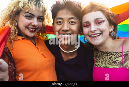 Happy gay friends having fun together during pride festival - LGBT and youth people lifestyle concept Stock Photo