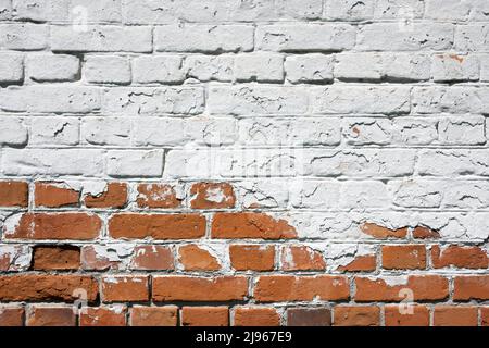 Grunge brick wall background with aging texture closeup. White and orange bricks Stock Photo