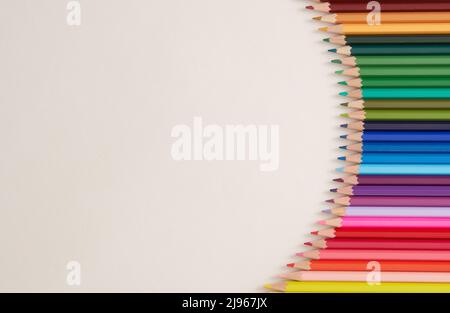 Seamless horizontal pattern Colored pencils arranged in a wave with copy space for note, text, on white background. Stock Photo