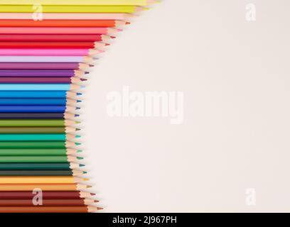 Seamless horizontal pattern Colored pencils arranged in a wave with copy space for note, text, on white background. Stock Photo