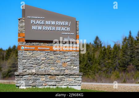 New River, NB, Canada - May 7, 2022: Large sign at the entrance to New River Beach. Below, Welcome in English, French, and two Indigenous languages. Stock Photo