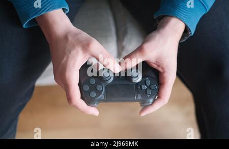 Joystick for game console in the mans hands.The concept of leisure and entertainment Stock Photo