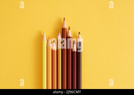 Colored pencils on the yellow background. Stock Photo