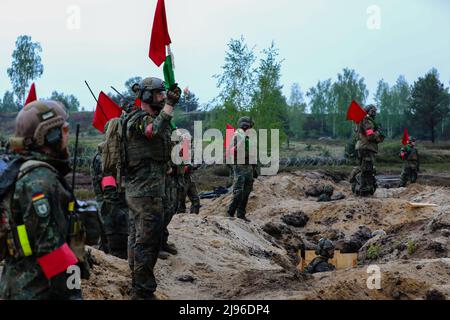 German soldiers assigned to the 212th Panzergrenadier Battalion, 21st Panzer Brigade, 1st Panzer Division, serve as safety officers during a live-fire exercise as part of Defender Europe at Oberlausitz Training Area, Germany, May 17, 2022. Defender Europe 22 is a series of U.S. Army Europe and Africa multinational training exercises in Eastern Europe. The exercise demonstrates U.S. Army Europe and Africa’s ability to conduct large-scale ground combat operations across multiple theaters supporting NATO. (U.S. Army National Guard photo by Staff Sgt. Gabriel Rivera) Stock Photo