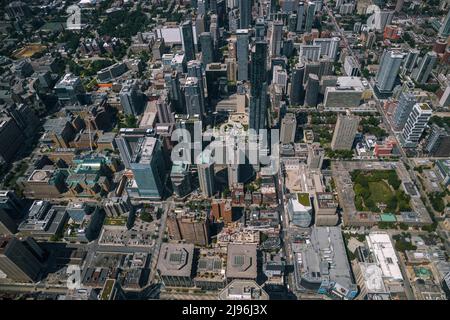 Aerial city view with crossroads and roads, houses, buildings, parks and parking lots, bridges. Helicopter drone shot. Wide Panoramic Stock Photo