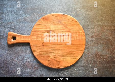 Round empty wooden chopping board made from acacia wood Stock Photo