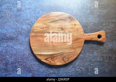 Round empty wooden chopping board made from acacia wood Stock Photo