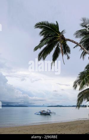 Port Barton, Philippines - May 2022: A fishing boat on the beach at Port Barton on May 16 2022 in Palawan, Philippines. Stock Photo