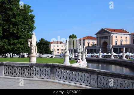 Prato della Valle in Padua City in ITALY in Veneto REGION is a wide public square with many statues of famous historical figures and a small water can Stock Photo