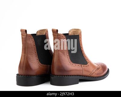 Women's autumn chelses brown leather boots isolated white background. Back side view. Fashion shoes. Photoshoot for shoe shop concept Stock Photo