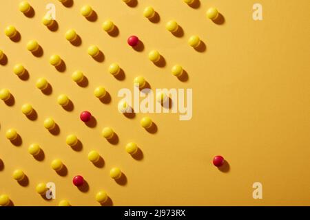 Yellow Chocolate candies on yellow Colored paper background Stock Photo
