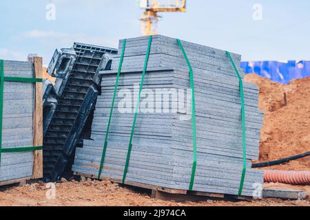 Industrial building cement pressed materials. Concrete block cement brick. Finished products on pallets compactly stacked wooden frame placed on Stock Photo
