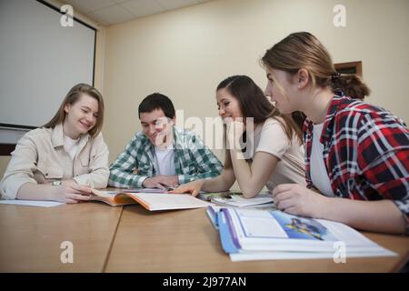 Group of college students talking in class Stock Photo
