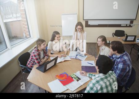 Top view shot of a female techer talking to her students during class at college Stock Photo