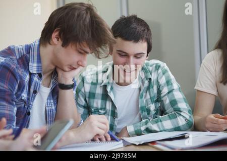 Young male students looking focused, studying at college class Stock Photo