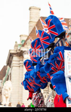 Street souvenir stall with velvet Union Jack top hats for sale Stock Photo
