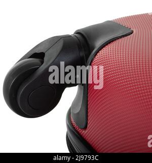 Black wheel of red travel bag isolated on white background close-up Stock Photo