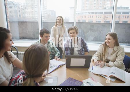 Female professor having class with university students Stock Photo