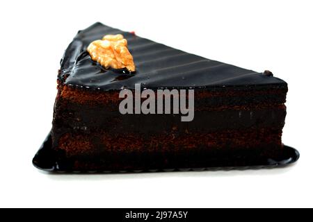 Fudge chocolate cake tart triangular piece made of fudge cake, walnut, butter, vanilla, flour, chocolate and eggs isolated on white background, select Stock Photo