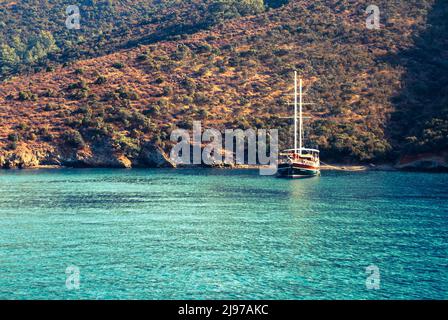 A touristic tour boat floating on bright blue sea. Göcek, Fethiye, Muğla Stock Photo