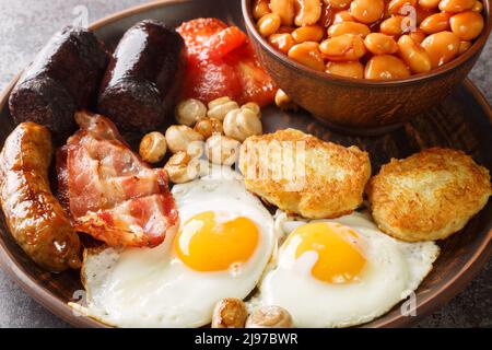 Traditional hot irish breakfast closeup in the plate on the table. Horizontal Stock Photo
